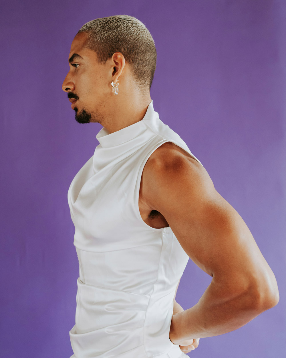 Person in a white outfit, celebrating authentic gender expression and confidence.