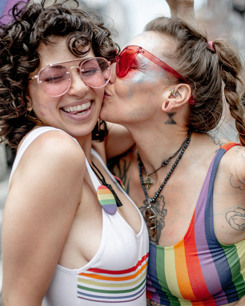 Two people embracing at a Pride celebration, representing LGBTQ+ pride and community.