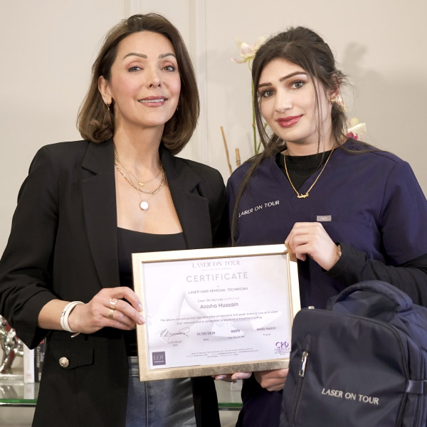 A photo of another of our franchisees, with our founder Neda, being presented with their certificate after completing their laser hair removal training.